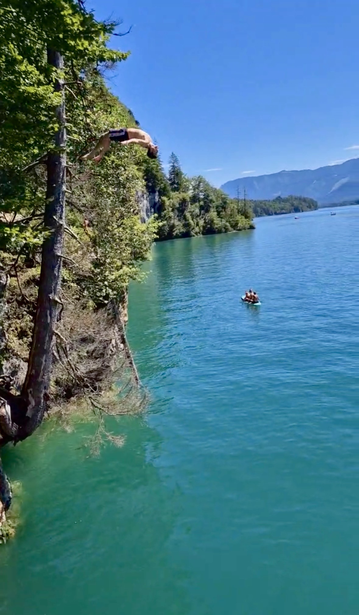 Angelo in the middle of a cliff-dive backflip