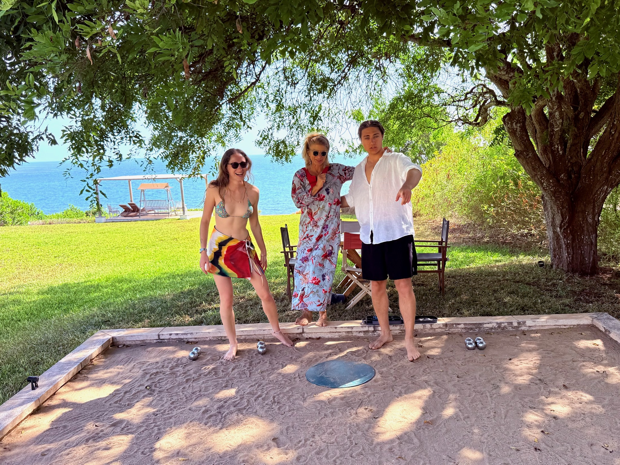 A tropical coastal lawn and sea view under shade trees