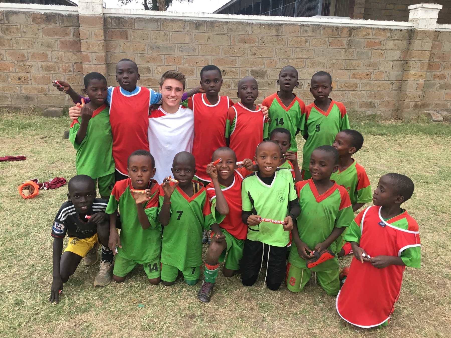 Angelo standing with the ACAKORO kids in Nairobi